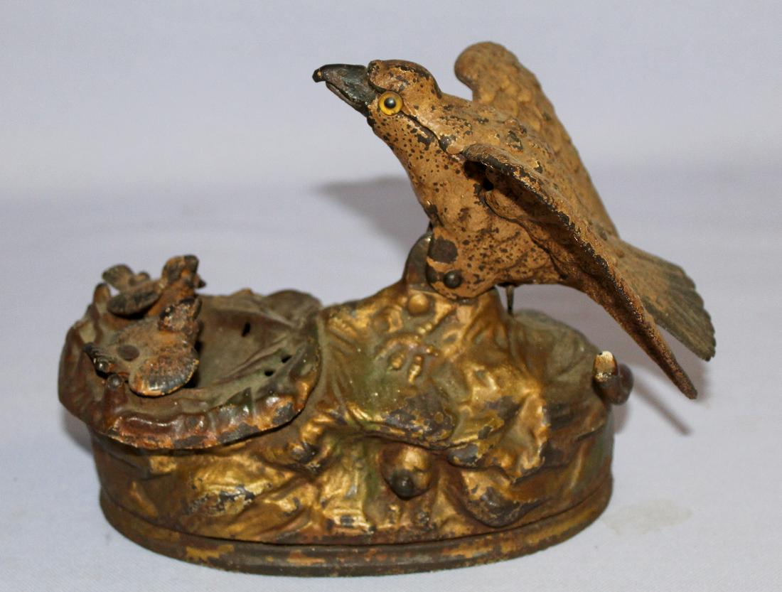 Vintage Cast Iron Eagle & Eaglets Bank. Maked Pat. Jan: Vintage Cast Iron Eagle & Eaglets Bank. Maked Pat. Jan 23, 1883; Painted white, gold and red. Works. Paint wear and chipping. 6" T x 6 1/2" W.