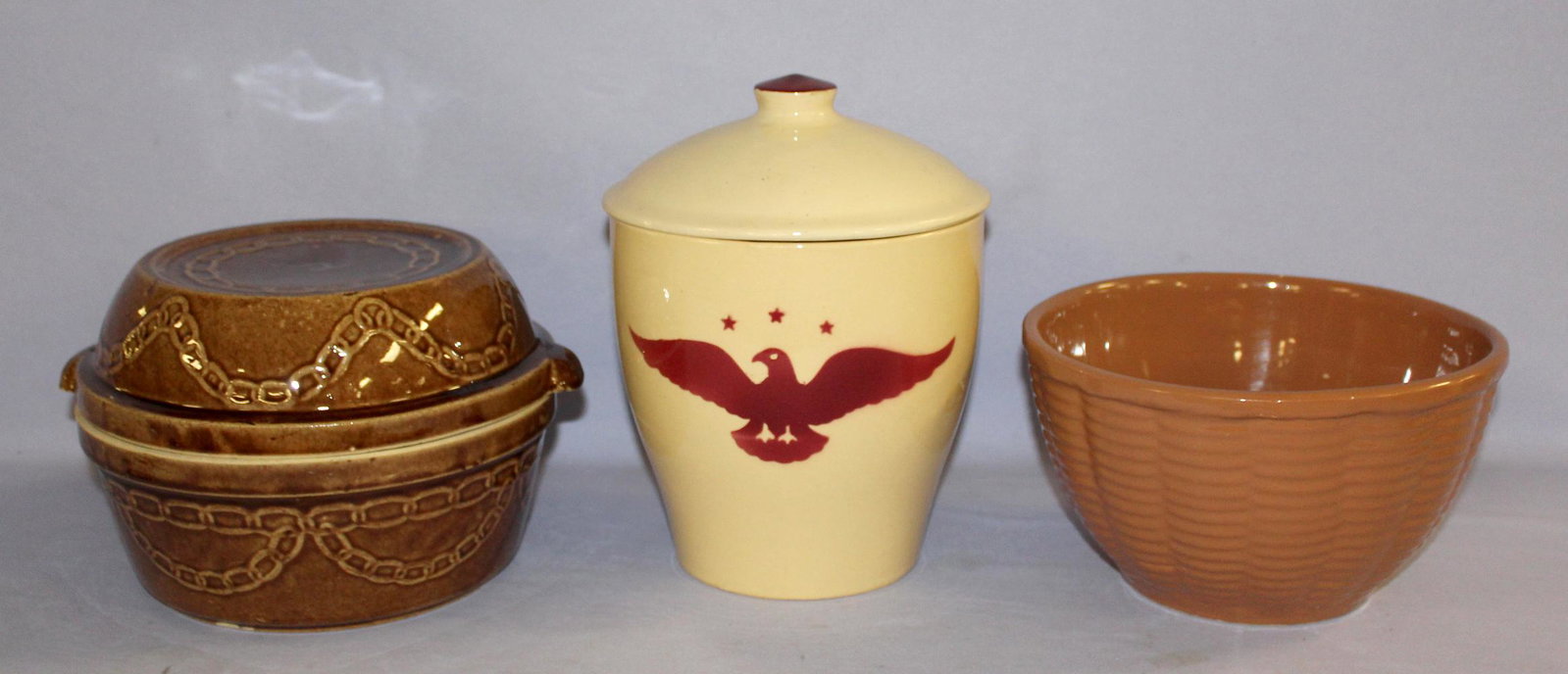 Watt and Monmouth Stoneware Dishes. 1.) Watt tapered: Watt and Monmouth Stoneware Dishes. 1.) Watt tapered Eagle #72 Cookie Jar. 2.) Marked Watt Basket weave #9 bowl, pink. 3.) Unmarked Monmouth borwn chain link patternlidded ditch oven, marked USA on th