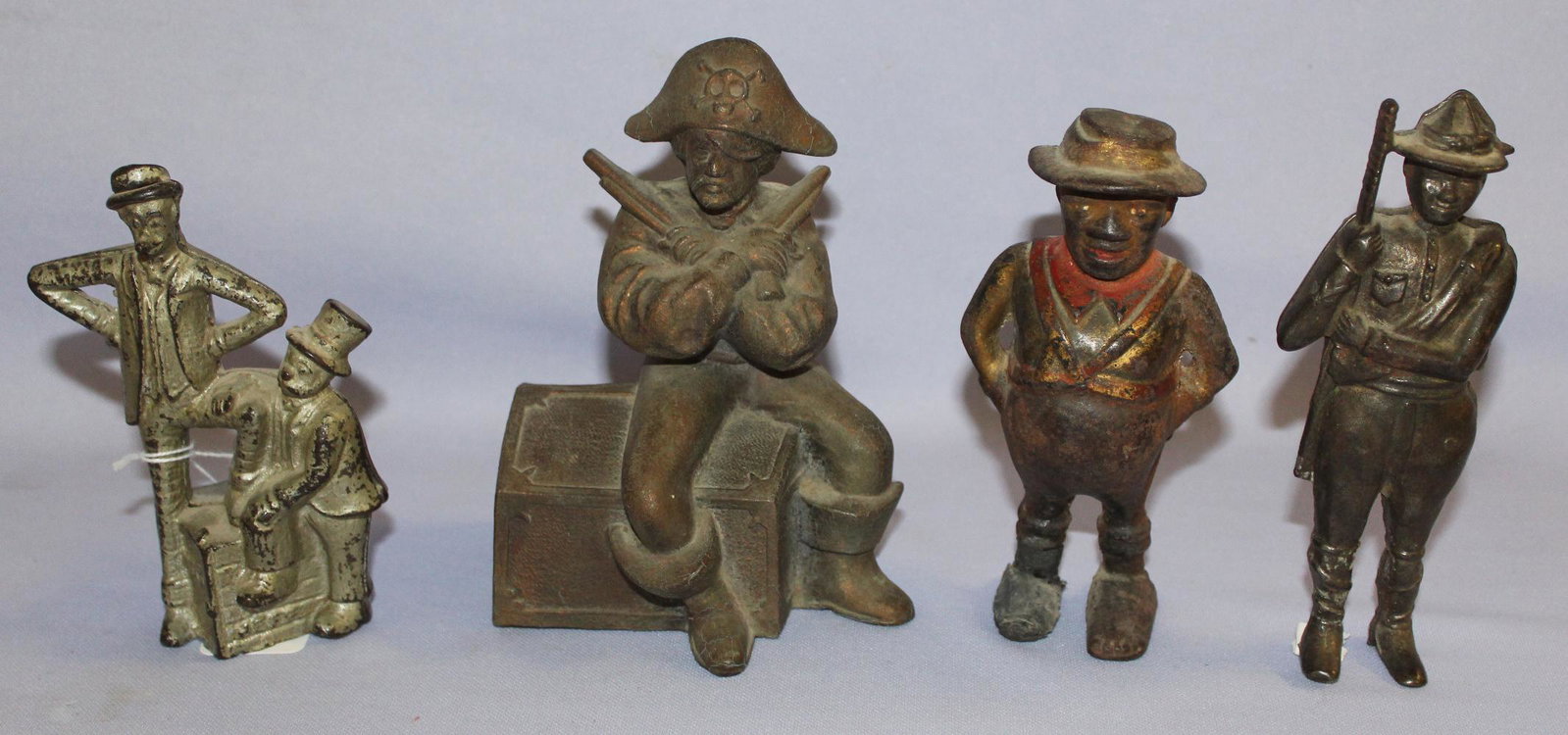 4 Antique Cast Metal Still Banks. 1.) Mutt and Jeff,: 4 Antique Cast Metal Still Banks. 1.) Mutt and Jeff, A.C Williams (Missing some paint) 2.) Boy scout (Solidier Boy) A.C Willia,s. No point, staff broken. Right back of leg is gone. 3.) Darkey (Share C