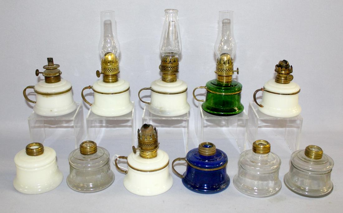 11 Antique "Nutmeg" Miniture Lamps. All embossed: 11 Antique "Nutmeg" Miniture Lamps. All embossed "Nutmeg"; 3 clear, 1 blue, 1 green, 6 opaque white; 6 have burners; 3 have chimney, remaining 5 burner rings (1 does not fit right); 6 have metal frame