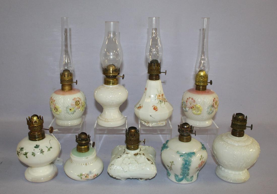 9 Antique Poaque Glass Miniature Kerosene Lamp. 7 with: 9 Antique Poaque Glass Miniature Kerosene Lamp. 7 with a molded pattern; 5 with visable paint; 4 have chimneys, all have brass burners. See photos. Tallest 4 1/2"