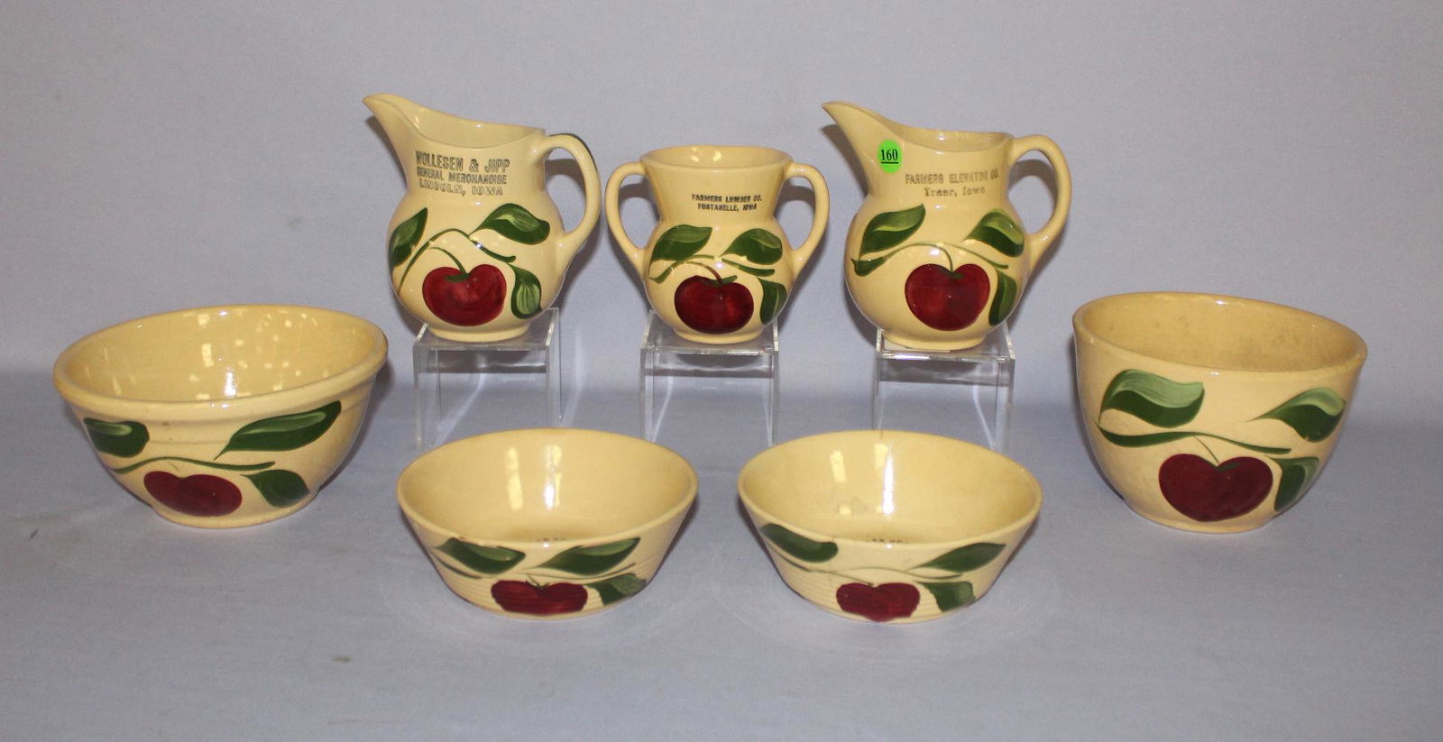 7 Watt Pottery Apple Tablewane Collectibles, 3 Leaf.: 7 Watt Pottery Apple Tablewane Collectibles, 3 Leaf. 1.) Sugar, advertising "Farmers Lumber Co., Fontanelle, IA" #98 (No Lid.) 2.) 2 Cream pitchers, 1 advertising "Farmers Elevator Co., Traer, IA"; th