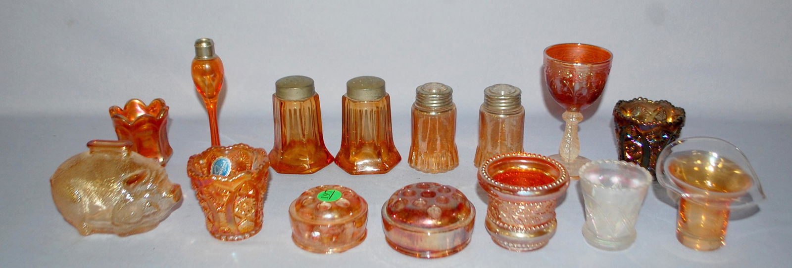 13 Carnival Glass Collectibles Assorted. 1.) Tree: 13 Carnival Glass Collectibles Assorted. 1.) Tree medallion goblet; marigold. 2.) Holly votive cup, marigold. 3.) 2 sizes of flower frogs; marigold. 4.) 4 Toothpick holders; paneled & imperial pattern