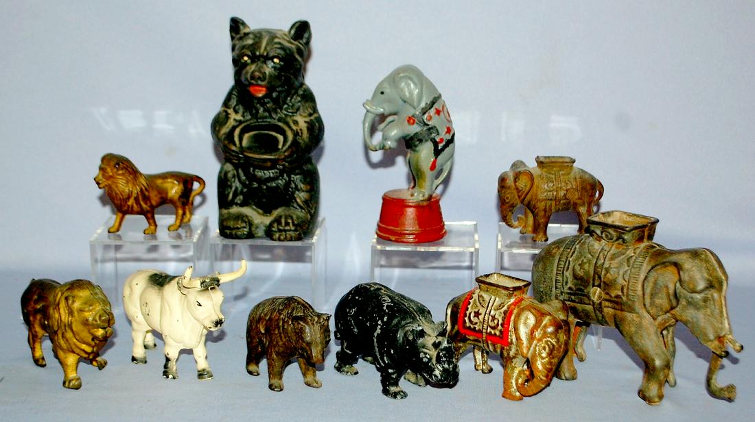 10 Vintage Cast Iron Still Banks, Animals: 1.) 3: 10 Vintage Cast Iron Still Banks, Animals: 1.) 3 Elephants with Howdahs; A.C. Williams. 2.) Elephant on tub, decorated; A.C> Williams. 3.) 2 Lion, tail between legs; unknown. 4.) Rhino; Arcade. 5.) Te