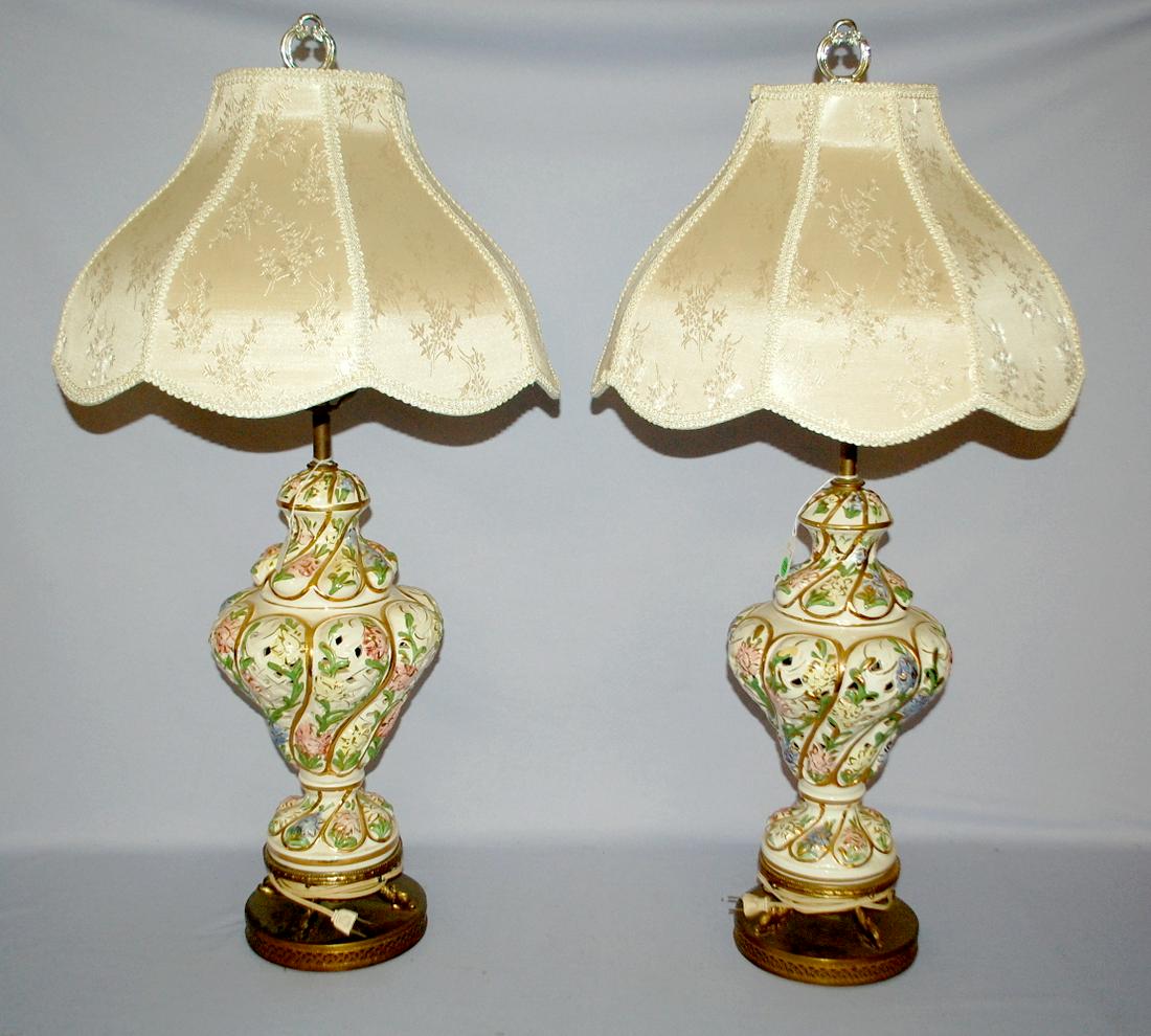 2 Vintage Electric Table Lamps. Floral. Metal base with: 2 Vintage Electric Table Lamps. Floral. Metal base with dolphin head feet holding the lamps; reticulated form with a twistedloop pattern; flowers painted on it. Turn swith on socket; fabric shade. Pla