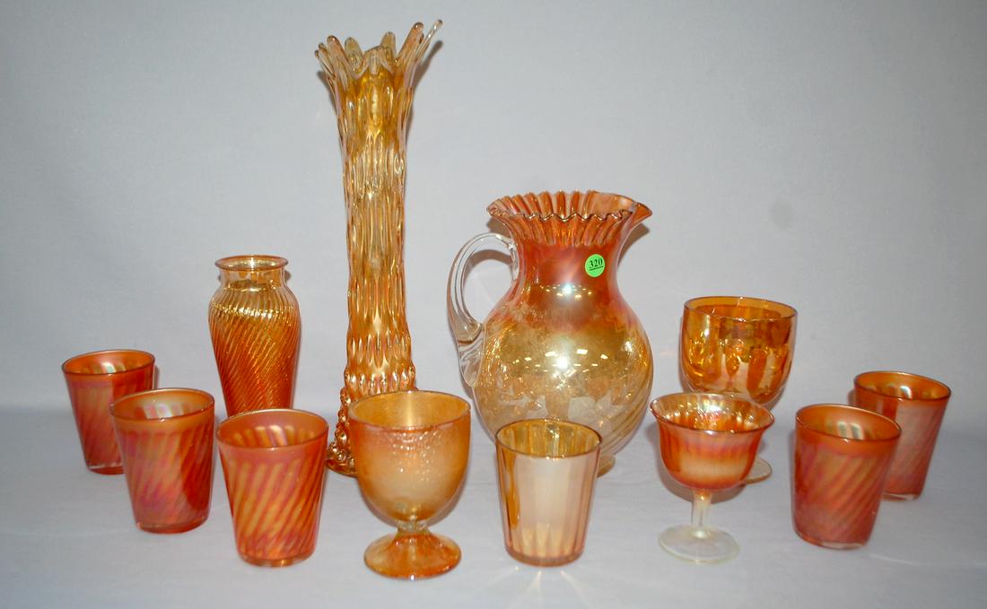 12 Marigold Carnival Glass Collectibles: 1.) Raindrop: 12 Marigold Carnival Glass Collectibles: 1.) Raindrop vase. 2.) Twisted Rib vase. 3.) Drape and Star goblet. 4.) Holly goblet. 5.) Tree of Life goblet. 6.) Paneled tumbler with horseshoe in the bottom