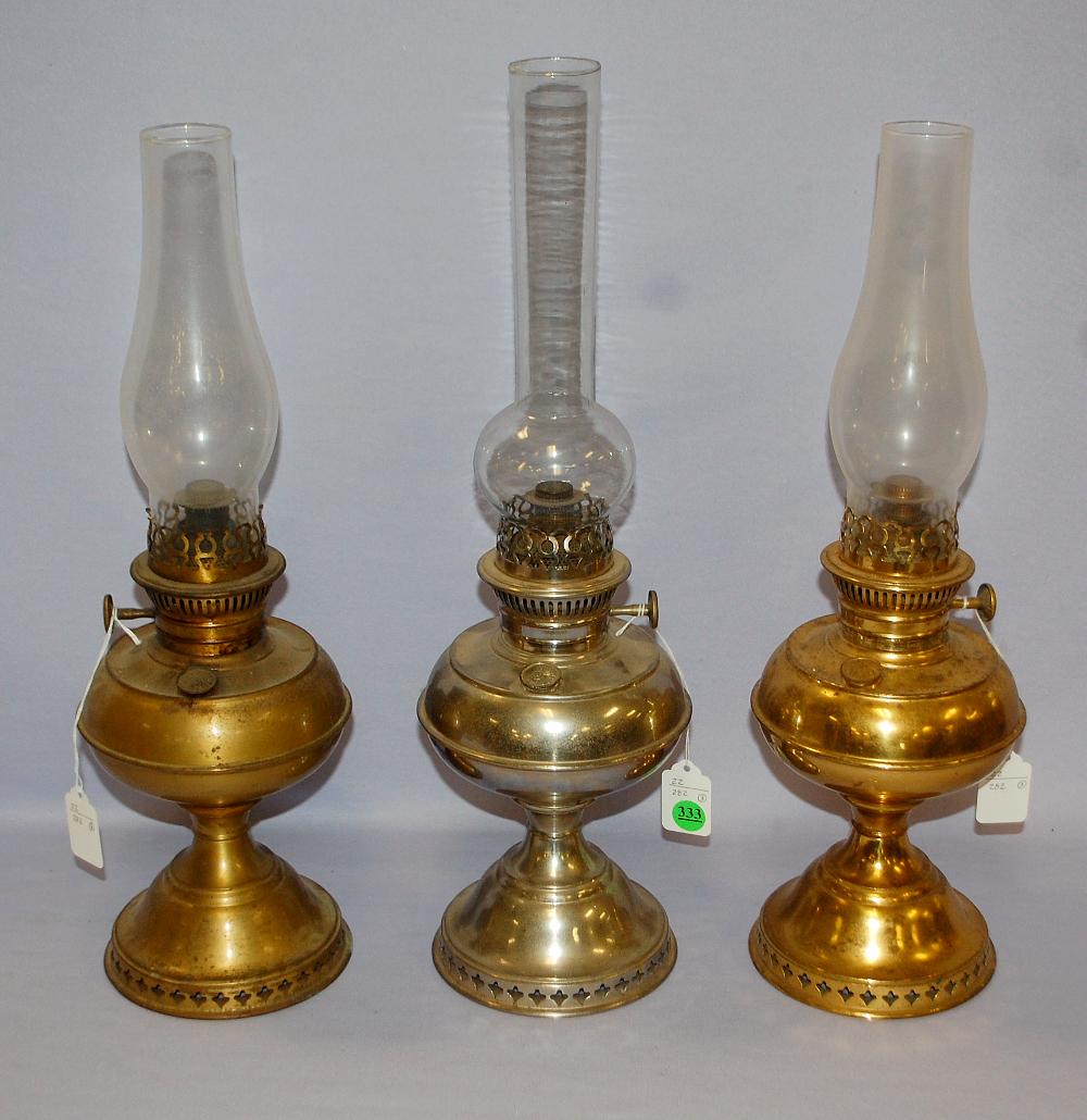 3 Antique Rayo Junior Kerosene Lamps: 2 brass and 1: 3 Antique Rayo Junior Kerosene Lamps: 2 brass and 1 nickel; all have fill caps; all have burners and all have chimneys. Tallest 14" to top of the burner.