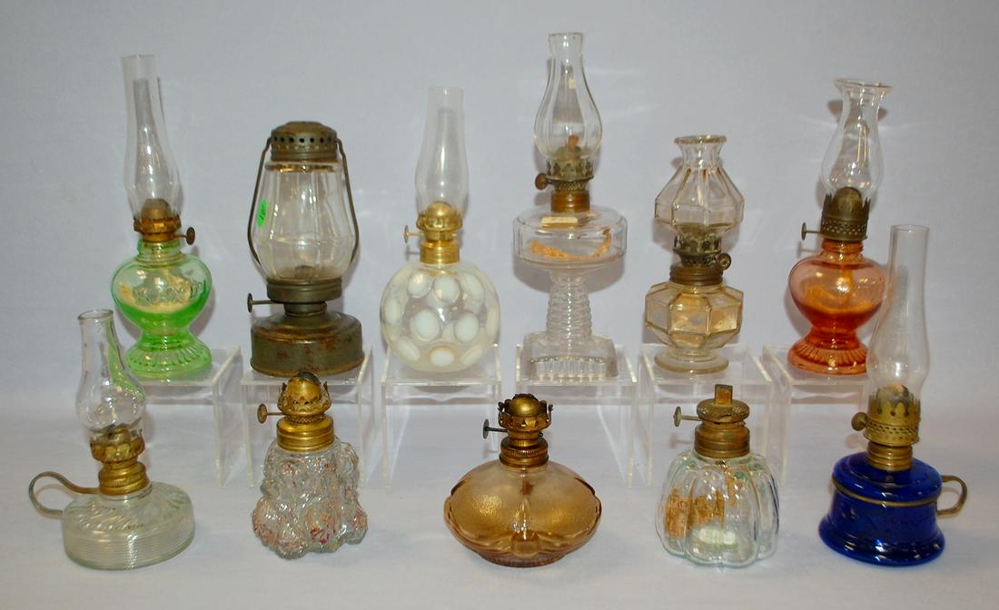 11 Antique Miniature Kerosene Lamps: 1.) White: 11 Antique Miniature Kerosene Lamps: 1.) White opalescent coin dot. 2.) Cobalt Nutmeg. 3.) Perko Wonder Junior barn lantern. 4.) 2 Handy Lamps, 1 green and 1 pink (Pink is chipped.) 5.) 6 clear, vario
