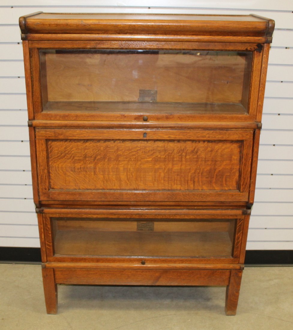 Antique Oak Globe Wernicke Sectional Bookcase: Antique Oak Globe Wernicke Sectional Bookcase: 3 sections; 2 glass lift up doors and one wood front section; has an interior label. Breaks down for moving. 50 1/2" T x 34" W x 12" D This item ships F.