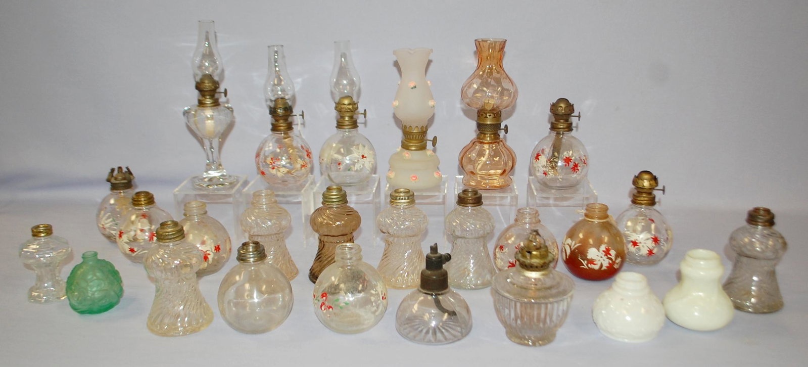 26 Antique & Vintage Miniature Kerosene Lamps: 26 Antique & Vintage Miniature Kerosene Lamps: This lot contains 26 assorted lamp bases; 10 with burners; 6 with burner rings; 5 chimneys. Some duplicate bases. See photos for more details. Tallest 6"