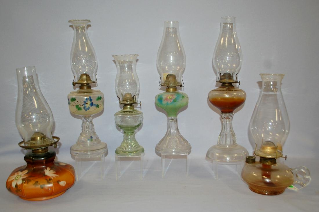 6 Antique Glass and Painted Kerosene Lamps: 6 Antique Glass and Painted Kerosene Lamps: all have burners and chimneys. 1.) Clear finger lamp. 2.) Clear light green with anchor pattern. 3.) Painted floral opaque glass with brown background. 4.) 