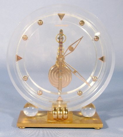 Jaeger-Le Coultre Skeletonized Desk Clock: Jaeger-Le Coultre Skeletonized Desk Clock: serial no.238, with an 8 day movement. The clear acrylic case stands on a brass base. 5 1/2" tall and running at this time All items sell As Is, Where Is, no