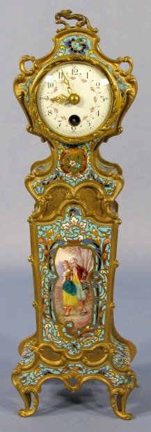 French Enameled Brass Mini Clock: French Enameled Brass Mini Clock: modeled after a floorr standing clock. It is enamel decorated on 3 sides with a main scene of a courting couple on front. The movement is numbered 452. The 2" dial is