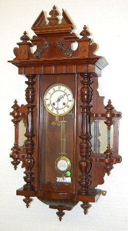 German RA Mirrorside Wall Clock: German RA Mirrorside Wall Clock: time and half hour gong striking with a 5 1/2" dial and RA pendulum. The case is mahogany. 37 1/2" long and running at this time All items sell As Is, Where Is, no gua