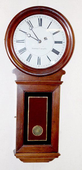 Boston Clock Co,. 1 Weight Wall Clock: Boston Clock Co,. 1 Weight Wall Clock: mahogany and veneer case with a 13 1/2" metal dial. Case and finish look good. Runs when properly leveled. (Dial has some paint loss around key hole.) 35 3/4" ta