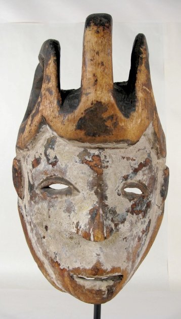 Carved & Painted Wood Ceremonial Mask: Carved & Painted Wood Ceremonial Mask: appears to be very early and of an unidentified tribe. Two loops and a curl decorate the hair. The face retains some of the white pigment used to color it. Made 