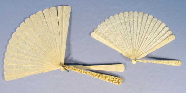 2 Carved Ivory Hand Fans: 2 Carved Ivory Hand Fans: 1.) The largest has deep carved scenes of people at various activities and flowers. When opened, there is a continuous and intricate scene of people and flowers. The veins ar