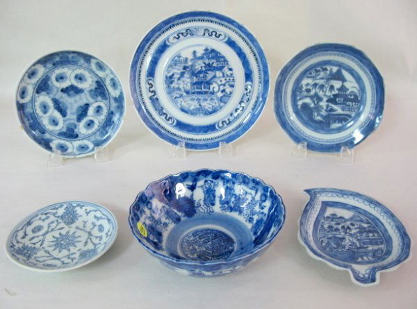 6 Blue & White Oriental Porcelain Dishes: 6 Blue & White Porcelain Dishes: 1.) Leaf shape with crowded central scene. 7 1/4" x 5 3/4" 2.) Canton with prunis trees, man and butterflies. 3" x 7 1/8" (Shows a lot of internal use. It has 2 old ha