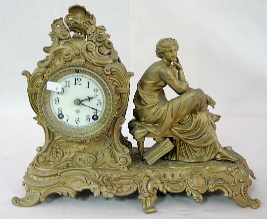 Ansonia "Clio" Statue Clock: Ansonia "Clio" Statue Clock: time and strike; porcelain dial with pendulum; gold patina 11" x 14" All items sell As Is, Where Is, no guarantees of any kind. We accept Mastercard & Visa, no paypal, no 
