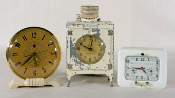 3 Electric Clocks Incl. G. E. Metal Refrigerator: 3 Electric Clocks Including G. E. Metal Refrigerator: 1.) General Electric Alarm on a plastic base; 2-CA-23 96 2.) Telechron Co. (With paint loss.) 3.) Westinghouse TC-81 Stove Timer/Clock. Tallest is
