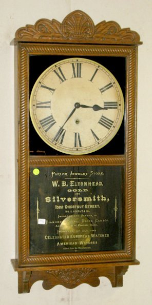 New Haven Referee Hanging Clock: New Haven Referee Hanging Clock: pressed oak case with a 12" dial. 8 day time only spring driven movement. There is some reverse painted advertising in gold letters on the lower door glass, which look