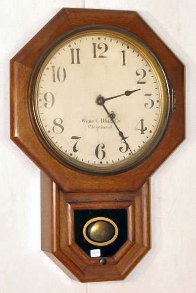 Seth Thomas 12" Drop Octagon Wall Clock: Seth Thomas 12" Drop Octagon Wall Clock: with an oak case; 12" dial and 8 day spring driven movement. The dial is marked Webb C. Ball Co. Cleveland. (The dial shows some wear. The case has a clean loo