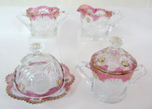 4pc. Red Flash Pattern Table Set: 4pc. Red Flash Pattern Table Set: big daisy center pattern. Covered butter, covered sugar, creamer and spooner. (Butter has chip on bottom plate.) Tallest is 6 1/2" All items sell As Is, Where Is, no