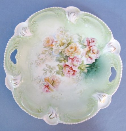 Unmarked RS Prussia Molded Cake Plate: Unmarked RS Prussia Molded Plate: green with pink and orange roses. Ring on bottom. Mold 207. (Gold wear.) 10" diameter All items sell As Is, Where Is, no guarantees of any kind. We accept Mastercard 