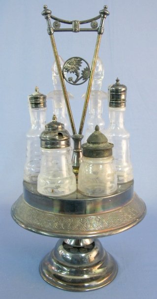 Pairpoint Mfg. Quad Plate Condiment Set: Pairpoint Mfg. Quad Plate Condiment Set: plated frame with center floral medallion in handle; 5 bottles are similar but not identical 2 lids match; 2 others are different. Marked Pairpoint Mfg. Co. an