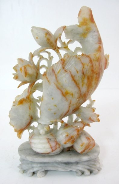 9" Figural Fish Soapstone Statue: 9" Figural Fish Soapstone Statue: gray stone base with carved carp type fish feeding on a plate that has blossoms going up the side. The soapstone has some natural rust coloration that the carver util