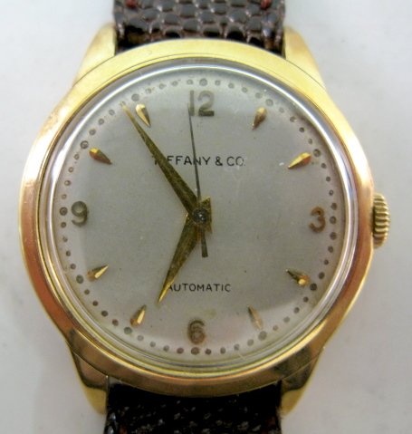 Movado for Tiffany & Co. 14K YG 17J Wrist Watch: Movado for Tiffany & Co. 14K YG 17J Wrist Watch: unadjusted; Automatic movement. In a yellow 14k gold case, numbered B226199 and 46159 and is screw on type. The silver dial with gold hands, markers an