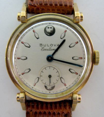 Bulova Excellency 21J Wrist Watch: Bulova Excellency 21J Wrist Watch: 10 BM; no serial no.; in a 10k gold filled Bulova case, numbered 1452896; metallic dial with bowling pins for numbers; bowling balls for 12 and 6; seconds dial at 6.