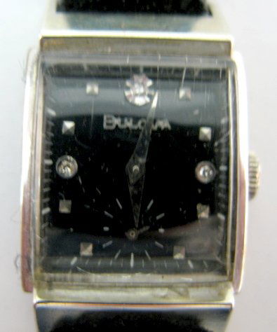 Bulova 21J 8AC Wrist Watch: Bulova 21J 8AC Wrist Watch: 2 positions; 5 adjustments; in a Bulova 10K gold filled case; black dial with clear stones at 12, 3 and 9; silver squares at all other numbers except 6; seconds dial at 6.