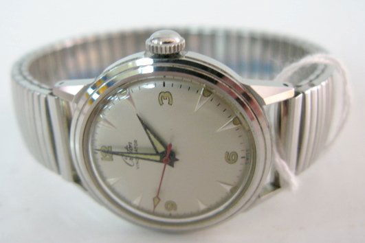 Croton Vindicator Incabloc Wrist Watch: Croton Vindicator Incabloc Wrist Watch: in a Croton Vindicator Waterproof; Shock Resistant stainless steel case, numbered AM451647. Silver colored dial with #'s 12, 3, 6 and 9 in gold outlined in blac