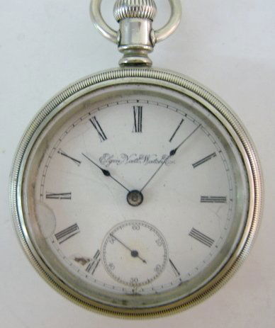 Elgin GR124 15-17J 18S OF SW/SS Pocket Watch: Elgin GR124 15-17J 18S OF SW/SS Pocket Watch: serial no.4551488; in a white screw A.W. & Co. case, numbered 62175. Pat. 1879-April 17. (The dial is damaged; the crystal and case are scuffed up.) Runni
