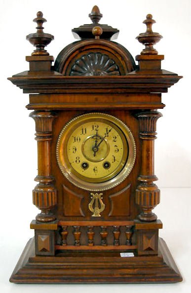 German Musical Mantle Clock: German Musical Mantle Clock: the time and strike movement is attached to a disc music player in the case's bottom area. The movement was not accessed, the case's backboard is nailed into place. A key 