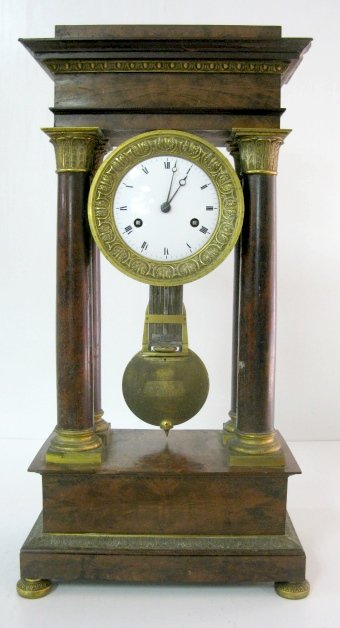Unmarked French Column Clock: Unmarked French Column Clock: it has a brass time and strike movement, but no bell or hammer to strike. The 4" dial has a cast bezel, it is porcelain. The suspension is that of a free swinger to suppo