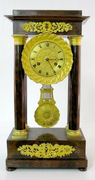 Pillar Clock w/Dore Metal Decoration: Pillar Clock w/Dore Metal Decoration: time with half hour bell striking movement, unmarked. The nice pendulum is connected to a piece of braided wire instead of a normal suspension. The case has a pol