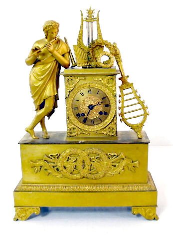 French Dore Figural Clock w/Silk String: French Dore Figural Clock w/Silk String: the time and bell striking movement is unmarked. The dial with decorative center and bezel is 3 1/2" wide. The case has a musical theme, including a flute play