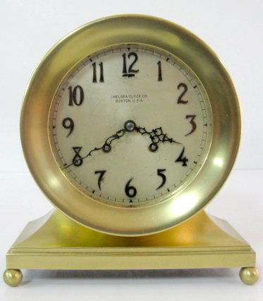 Chelsea Ships Bell Clock No.68296: Chelsea Ships Bell Clock No.68296: 8 day time with half hour ships bell strike. The dial is 5 1/2" wide and has applied black numbers. The case is brass with inset wood bottom. With a key. (The dial h