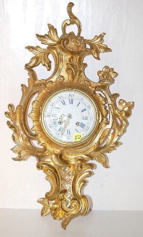 Japy Freres & Cie Bronze Cartel Clock: Japy Freres & Cie Bronze Cartel Clock: The time and bell striking movement is signed and numbered 65112. The blue and white porcelain dial is 5" wide and set in a floral and scroll case. (Not running;