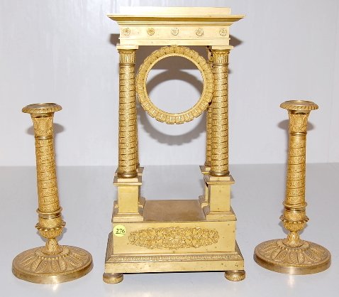 French Bronze Dore Garniture: French Bronze Garniture: no movement; the 4 column has roses in relief around the columns. The 2 candlesticks have griffins & lyres around the stem. (No movement with the case. The metal has some scat
