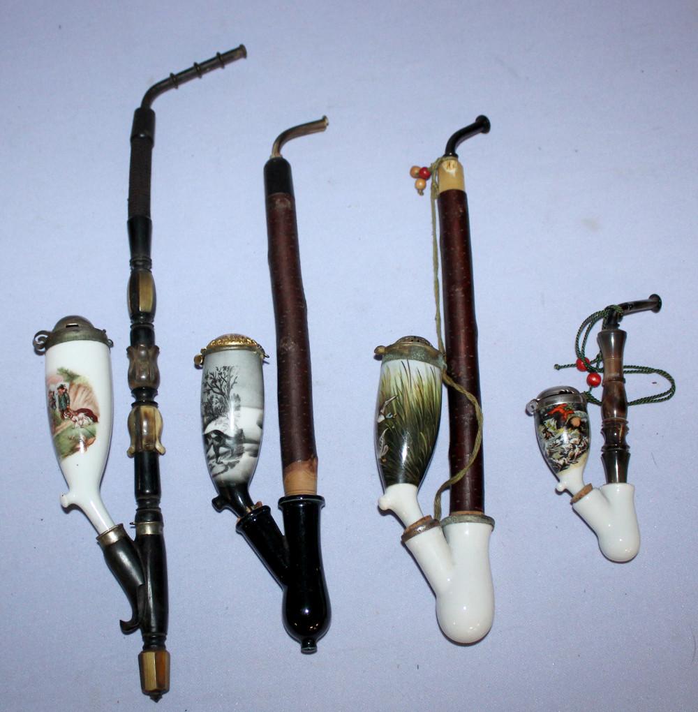four antique porcelain pipes w/m stems: four antique porcelaine pipes w/m stems. Dogs with rabbit, hunter with deer, ducks, proud hunter with deer. The longest is 15 1/2"