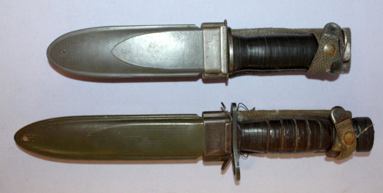 US bayonet and fighting knife in scabbards: US bayoets and a fighting knife in scabbards. 1- m4 carbine bayonet made by case circa 1944-45 in m-8 scabbard. 11 1/2" long. 2- EGW fighting knife (EG Waterman) in USN M1 scabbard 9" long. Both have