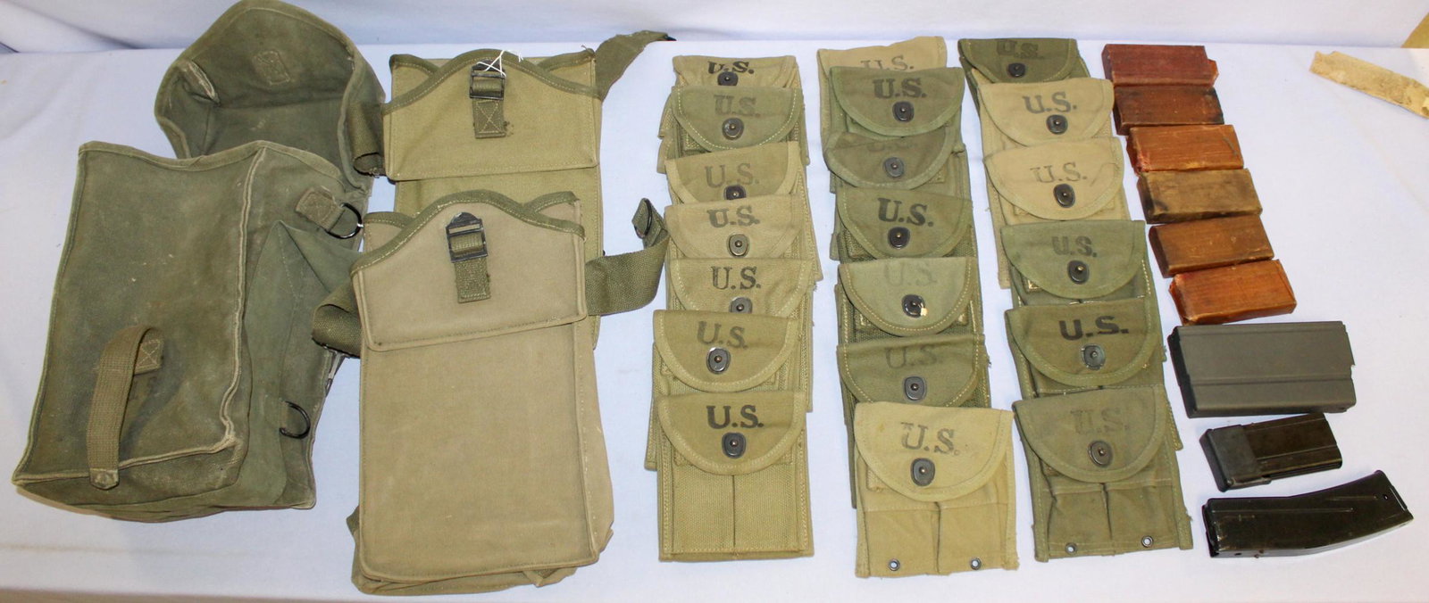Pocket magazines and bags: 25 US Pocket magazines and three bags for 30 cal. Ammo. Also 7 magazines for the m1 carbine, one has ammo in it. The pocket magazines are 5 1/4" by 4 1/4"; the bag is dated 1944 and is 12" by 7 1/2" b