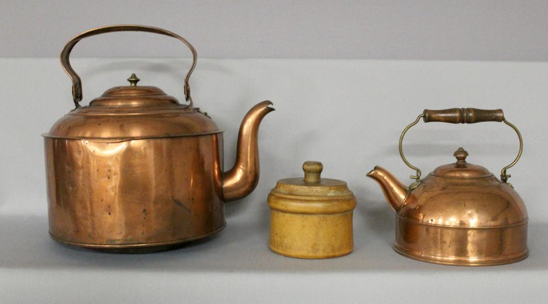 Two Copper Tea Pots and a Butter Mold: 2 copper tea pots and a butter mold- with wooden bail handle, 8" tall - light use. 3- antique wooden butter mold one pound plunger style with floral design.