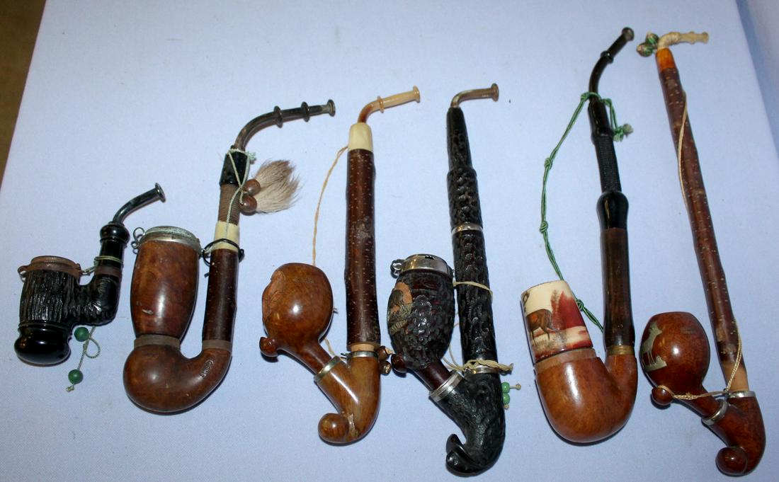 six antique smoking pipes: six antique smoking pipes. Brian and wood, one with dÃ©cor porcelain bowl. Wood stems. The longest is 13"