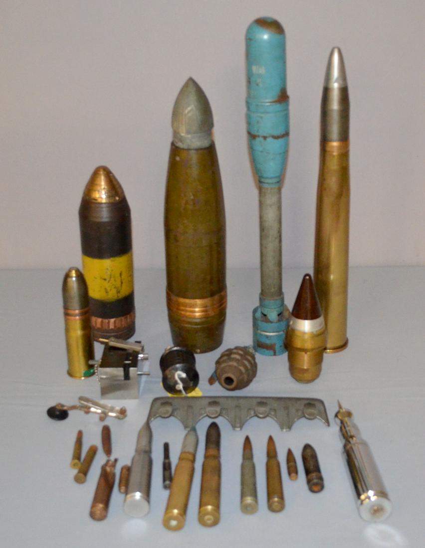 Mixed lot of 26 Americans and other ammo related items: Mixed lot of 26 American and other ammo related items. Japanese American grenades - the Japanese is type 97; practice rocker for tank assault; canon shell fuse; US WW1 75mm fuses and fired warhead; 90