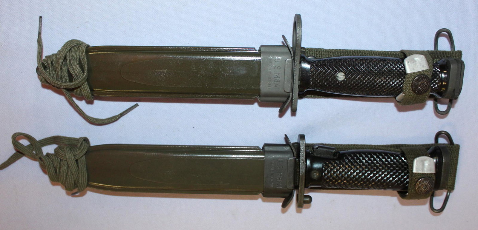 2 US Mark 7 bayonets and scabbards.: 2 US Mark 7 Bayonets and Scabbards from the Vietnam Era, One is made by Colt and the other is Imperial. In new Condition. 11 7/8" long.