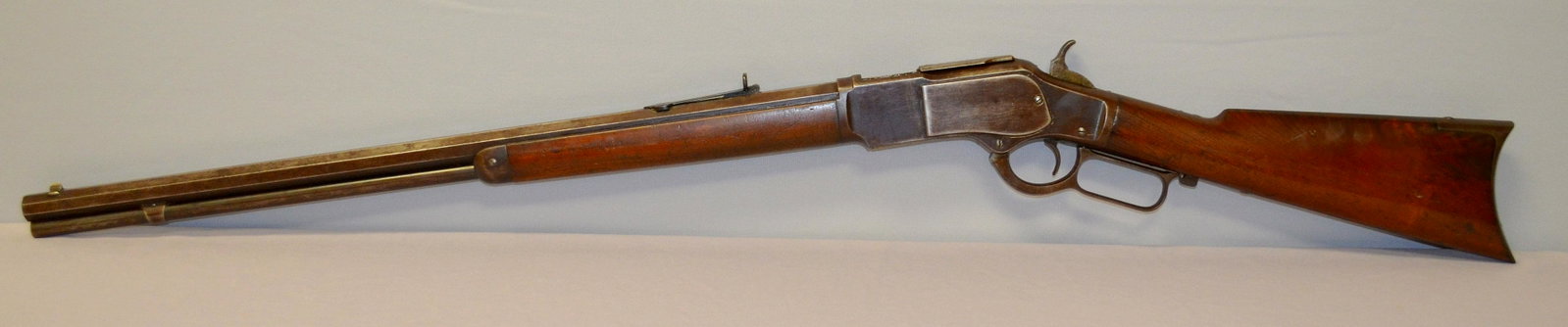 Winchester Model 1873 32-20 Lever Action Rifle: Winchester Model 1873 32-20 Lever Action Rifle. 23 1/2" Octagon barrel with full length tube below it. Rifle circa 1885, walnut stock and forearm, serial No. 190942B. In used but very good condition. 